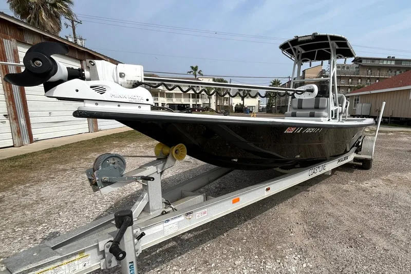 Slide: The Image of 2018 Majek 25 Extreme boat on trailer, parked outdoors. - 2