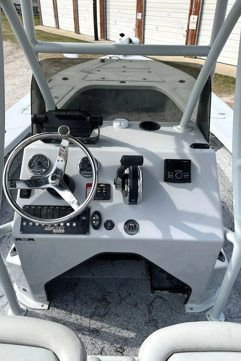 Slide: The Image of 2018 Majek 25 Extreme boat console with steering wheel and controls. - 9