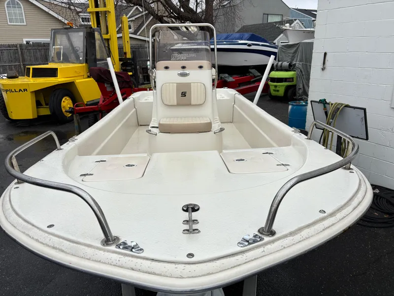 Slide: The Image of 2014 Carolina Skiff JVX18CC boat, white deck, parked outdoors. - 10