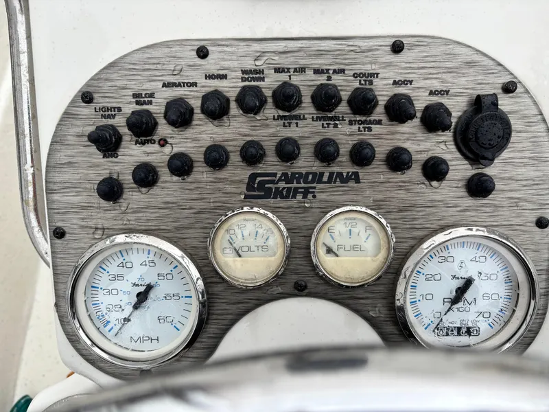 Slide: The Image of Control panel of a 2014 Carolina Skiff JVX18CC boat with gauges and switches. - 7