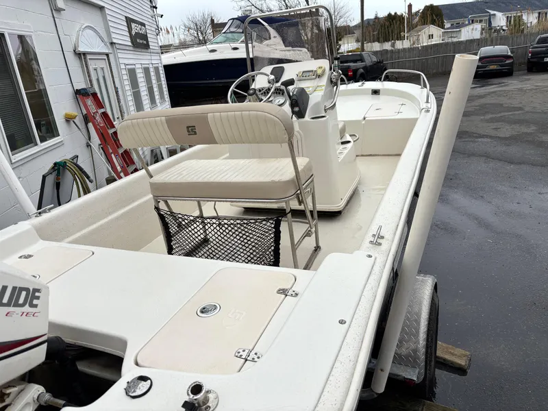 Slide: The Image of 2014 Carolina Skiff JVX18CC boat with Evinrude E-TEC engine, parked outdoors. - 8