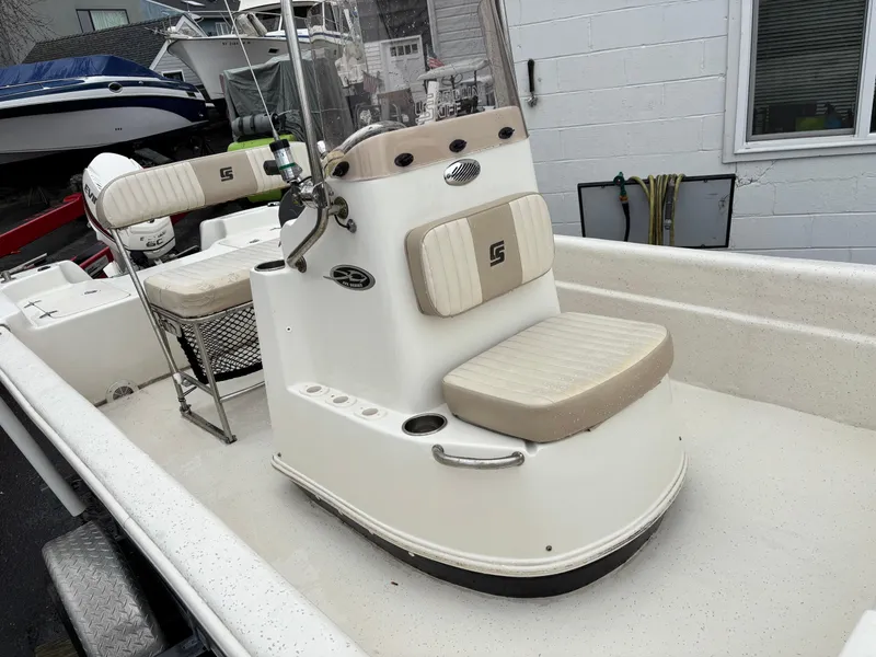 Slide: The Image of 2014 Carolina Skiff JVX18CC boat interior with beige seating and console. - 9