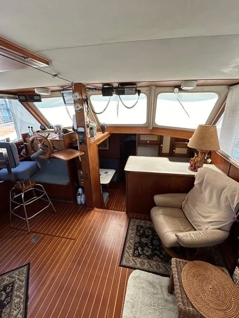 Slide: The Image of 1971 Uniflite 42 DC boat interior with wood paneling, helm, seating, and nautical decor. - 12