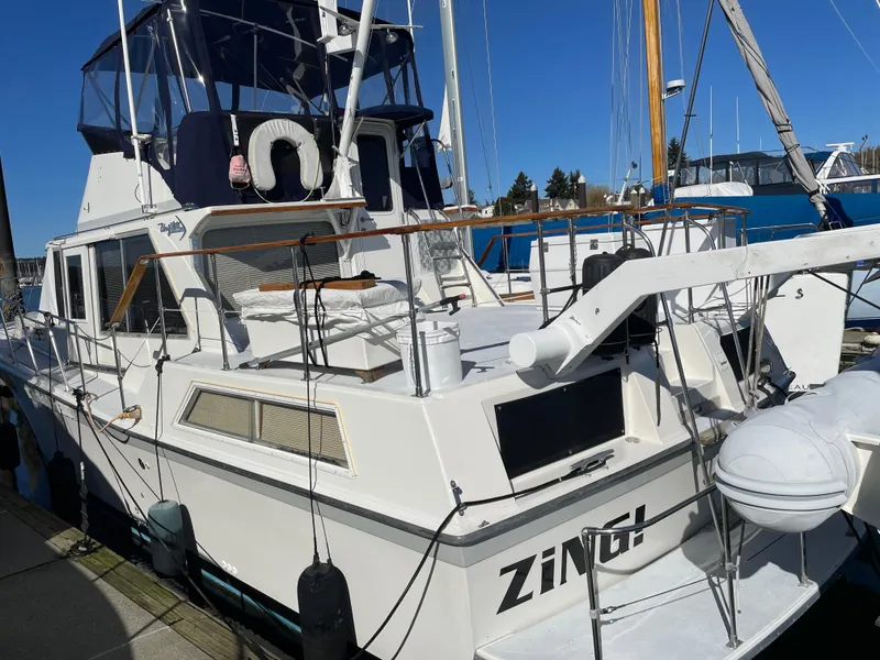 Slide: The Image of 1971 Uniflite 42 DC yacht docked, featuring a spacious deck and classic design. - 3