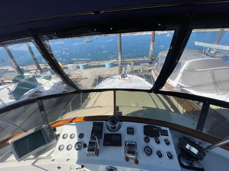 Slide: The Image of 1971 Uniflite 42 DC yacht helm with ocean view and docked boats. - 6