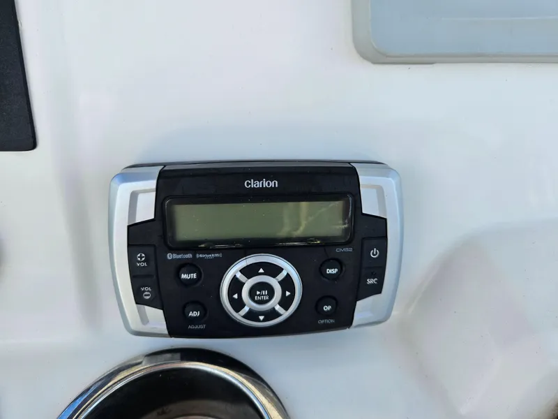 Slide: The Image of Clarion marine stereo system on 2017 Robalo 222 boat dashboard. - 12