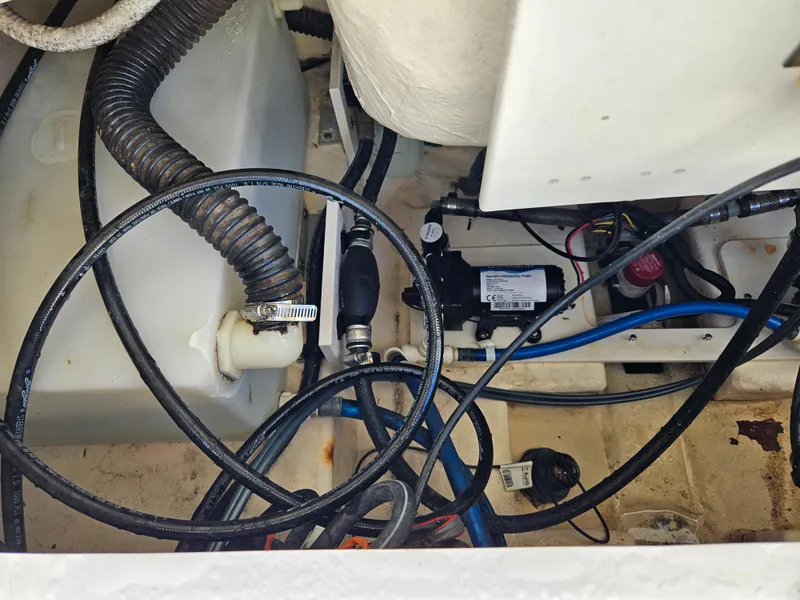 Slide: The Image of Engine compartment of a 2017 Robalo 222 boat, showing hoses and wiring. - 14