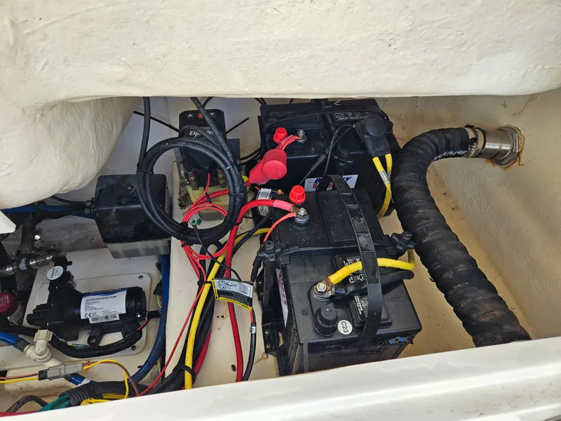 Slide: The Image of 2017 Robalo 222 boat battery compartment with wiring and connections. - 15