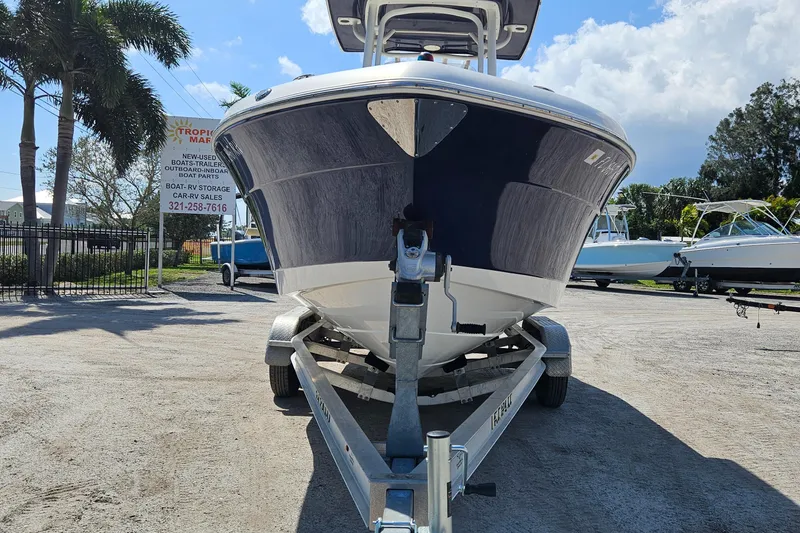 Slide: The Image of 2017 Robalo 222 boat on trailer, parked outdoors under a clear blue sky. - 18