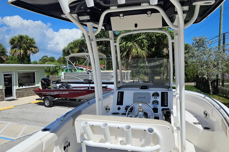 Slide: The Image of 2017 Robalo 222 boat interior with console, parked outdoors under clear blue sky. - 20