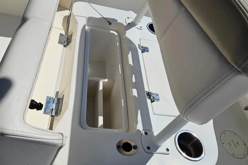 Slide: The Image of 2017 Robalo 222 boat interior with open storage compartment and cup holders. - 22