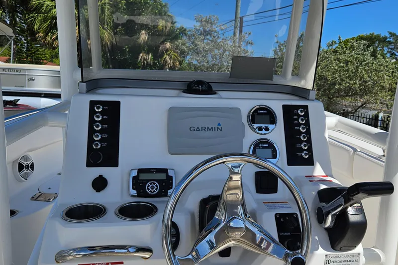 Slide: The Image of 2017 Robalo 222 boat dashboard with Garmin navigation system and steering wheel. - 26