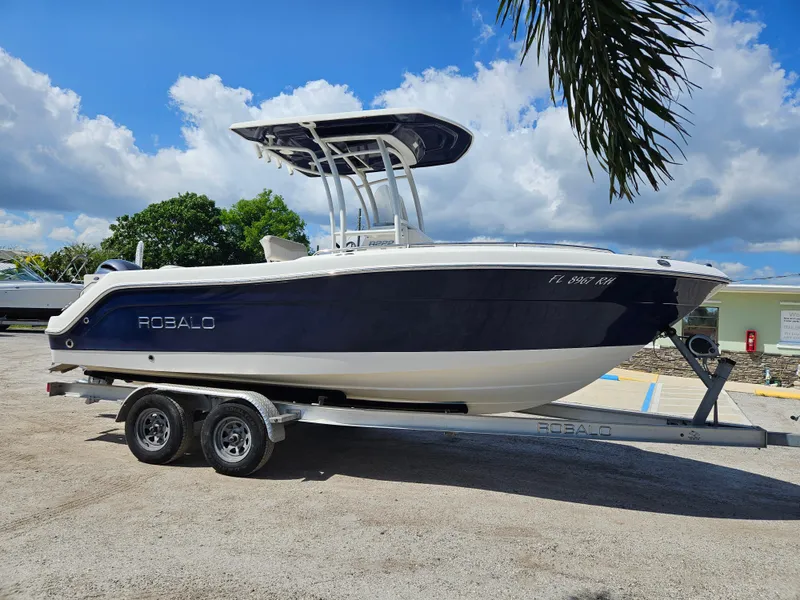 Slide: The Image of 2017 Robalo 222 boat on trailer under blue sky. - 3