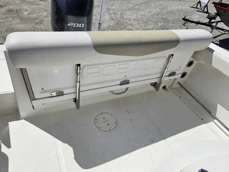 Slide: The Image of 2017 Robalo 222 boat interior with cushioned seating and visible engine. - 5