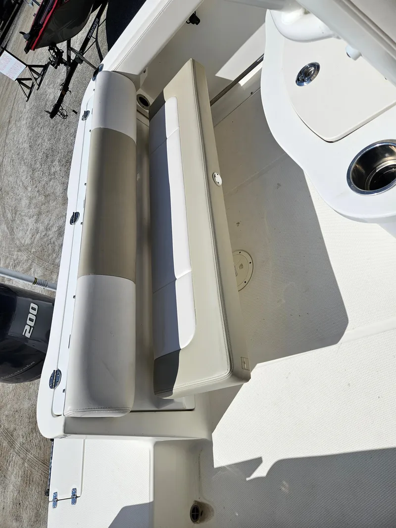 Slide: The Image of 2017 Robalo 222 boat interior with foldable seating and storage. - 6