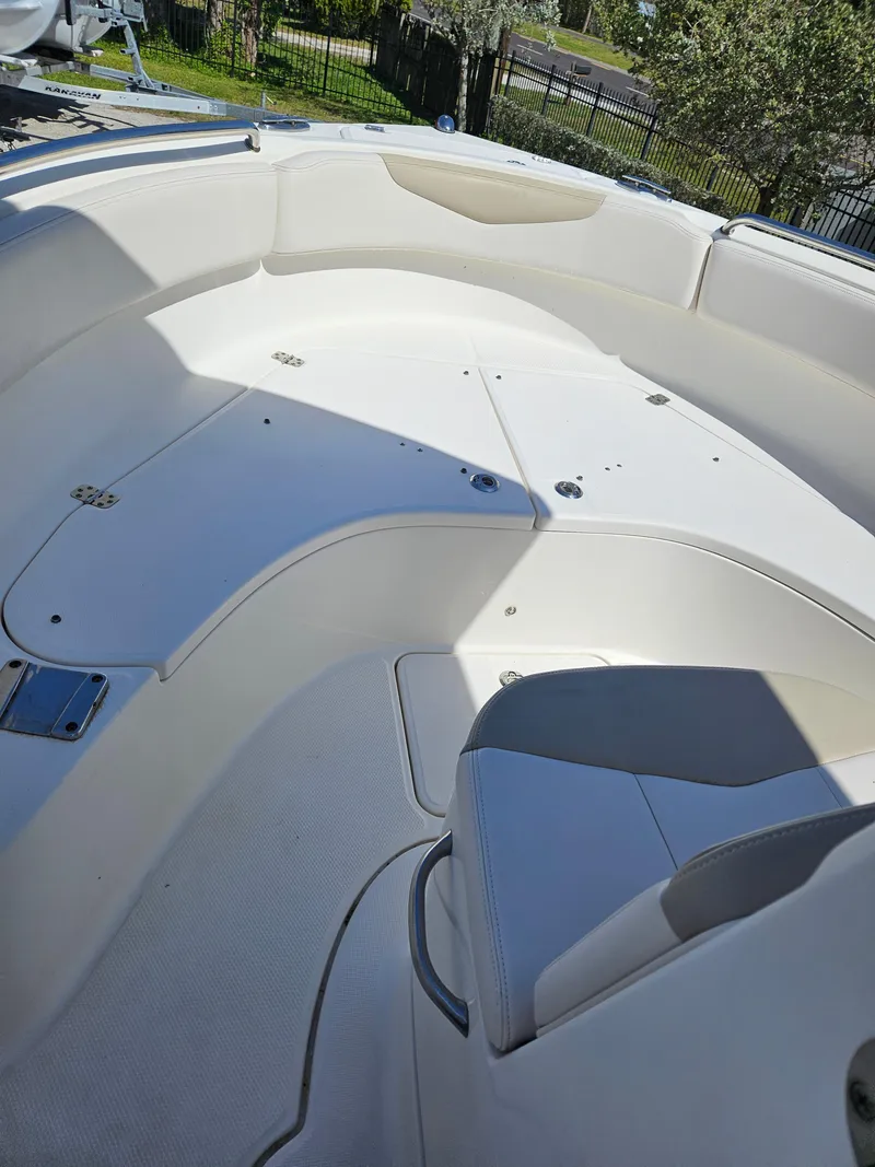Slide: The Image of 2017 Robalo 222 boat interior with white seating and storage compartments. - 9