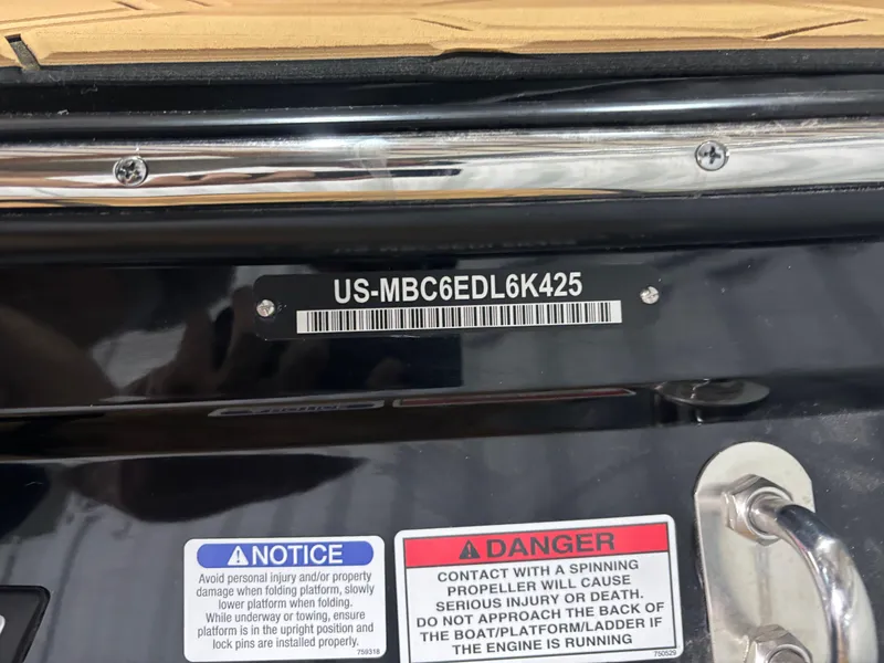 Slide: The Image of 2025 MasterCraft NXT22 boat identification plate with safety warnings and serial number. - 14