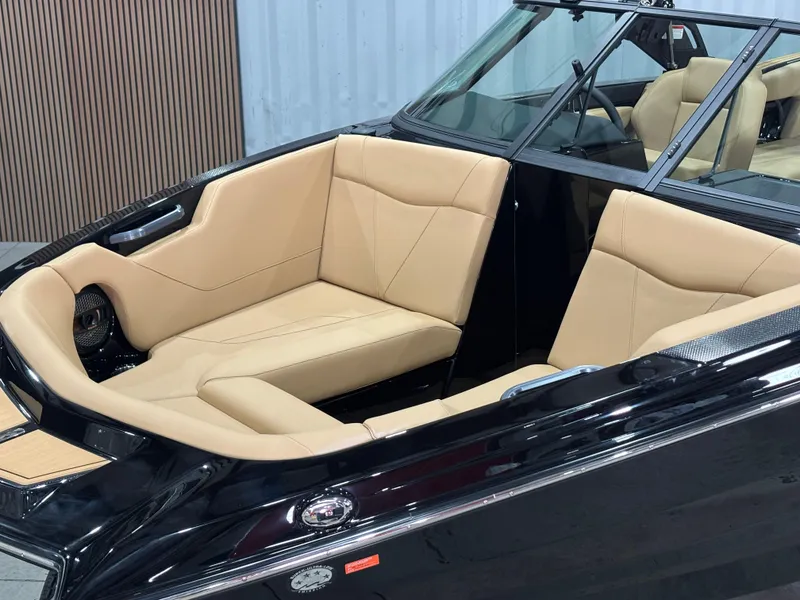 Slide: The Image of 2025 MasterCraft NXT22 boat with luxurious tan seating and sleek black exterior. - 3