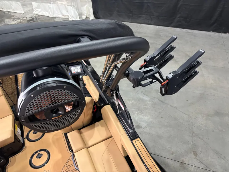 Slide: The Image of 2025 MasterCraft NXT22 boat interior with speaker and wakeboard rack. - 7