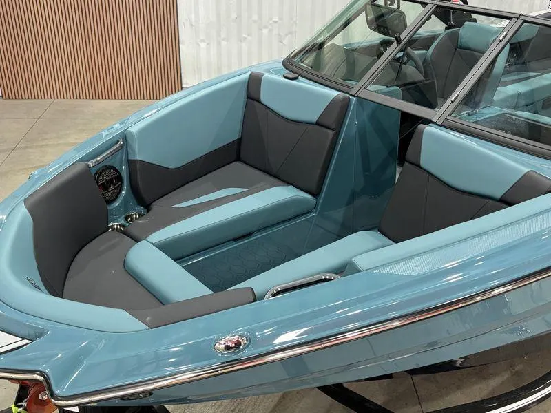 Slide: The Image of 2025 MasterCraft NXT23 boat interior with blue and gray seating, modern design. - 5