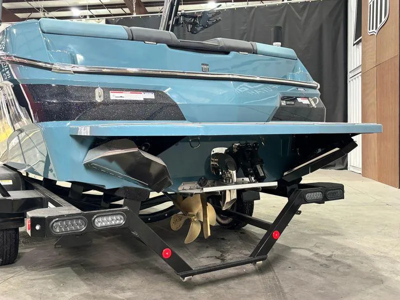 Slide: The Image of 2025 MasterCraft NXT23 boat rear view, showcasing propeller and hull design. - 6