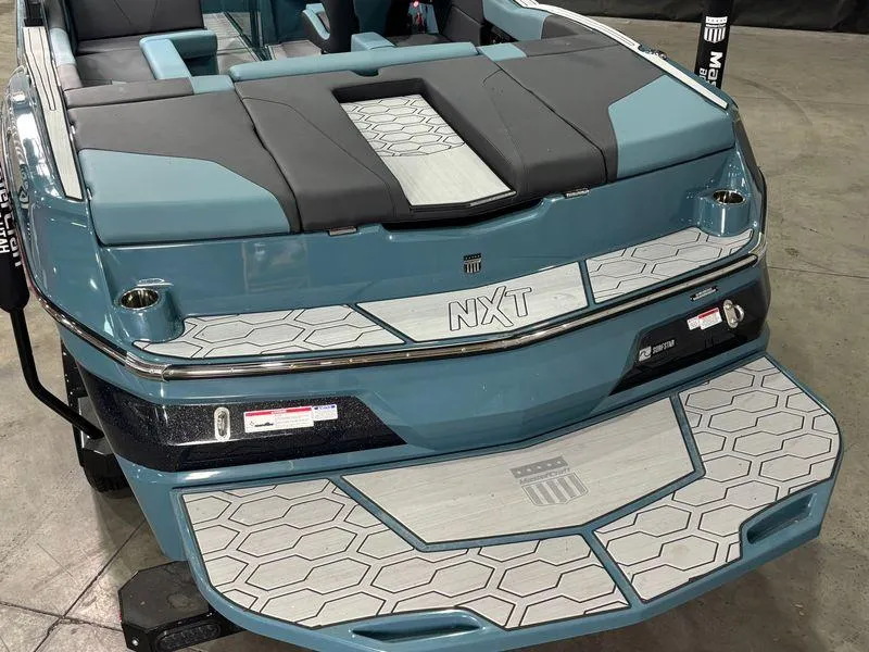 Slide: The Image of 2025 MasterCraft NXT23 boat, rear view, featuring sleek design and modern detailing. - 7