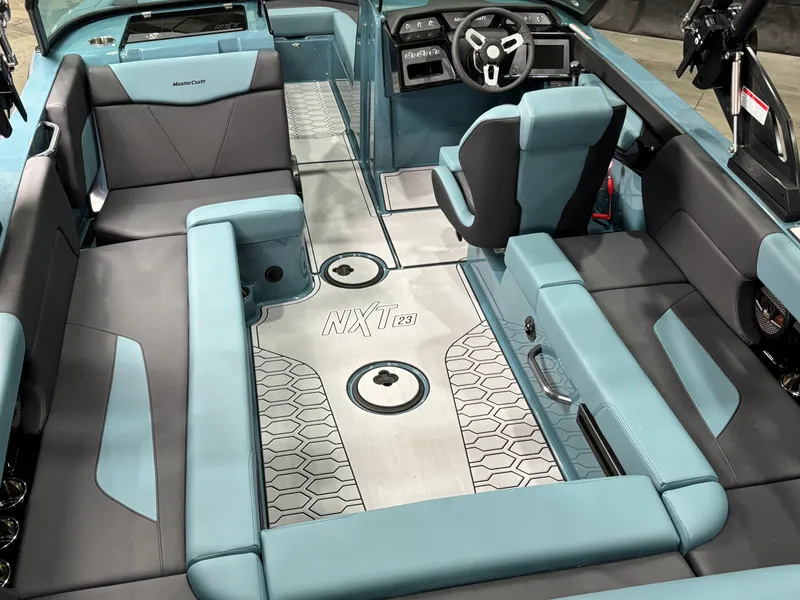 Slide: The Image of 2025 MasterCraft NXT23 boat interior with modern seating and sleek design. - 8