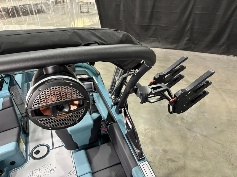 Slide: The Image of 2025 MasterCraft NXT23 boat interior with speaker and wakeboard rack. - 9