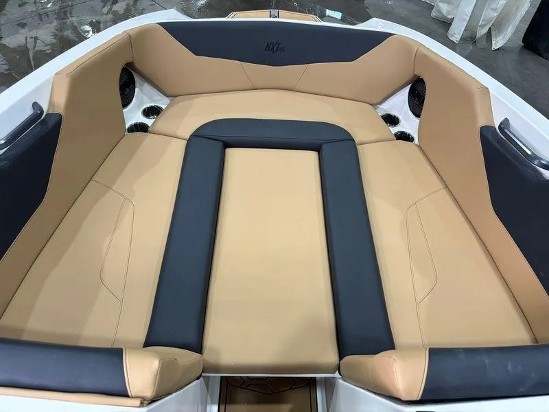 Slide: The Image of Luxurious seating in the 2025 MasterCraft NXT24 boat, featuring tan and black upholstery. - 12