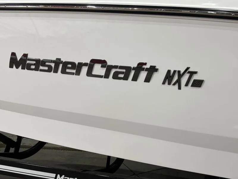 Slide: The Image of 2025 MasterCraft NXT24 boat logo on white hull. - 4