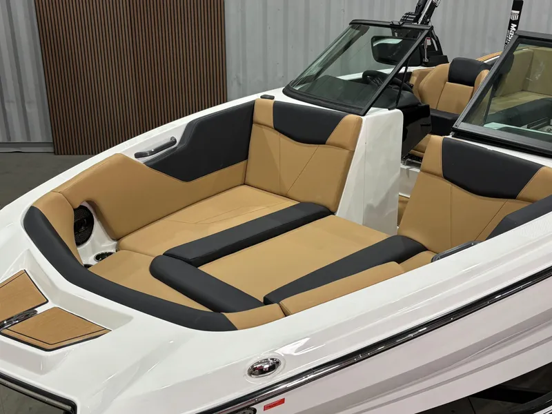 Slide: The Image of 2025 MasterCraft NXT24 boat interior with tan and black seating. - 5