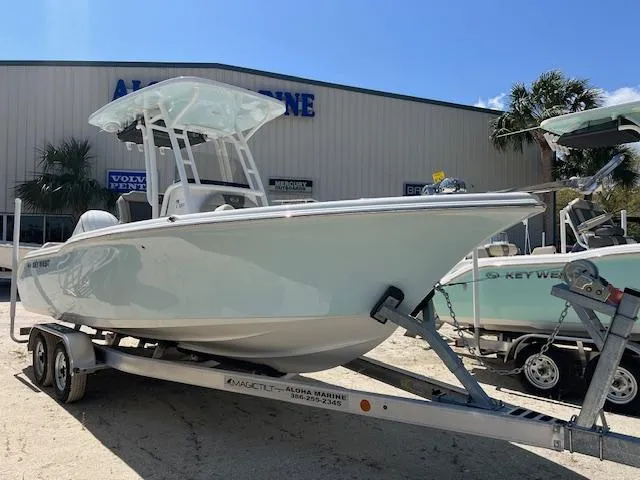 The Image of 2025 Key West 239 FS boat on trailer at dealership, sunny day. - 1