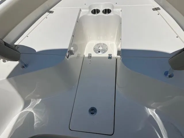 Slide: The Image of 2025 Key West 239 FS boat interior with storage compartment and cup holders. - 14