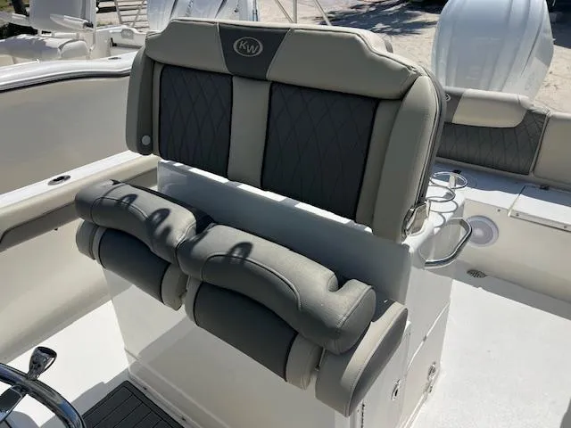 Slide: The Image of 2025 Key West 239 FS boat seating with cushioned backrest and cup holders. - 5