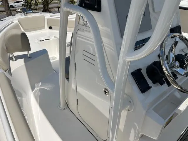Slide: The Image of 2025 Key West 239 FS boat interior with steering wheel and seating area. - 8