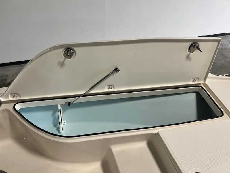 Slide: The Image of 2024 Sea Born FX 21 BAY boat storage compartment open, showcasing interior space. - 10