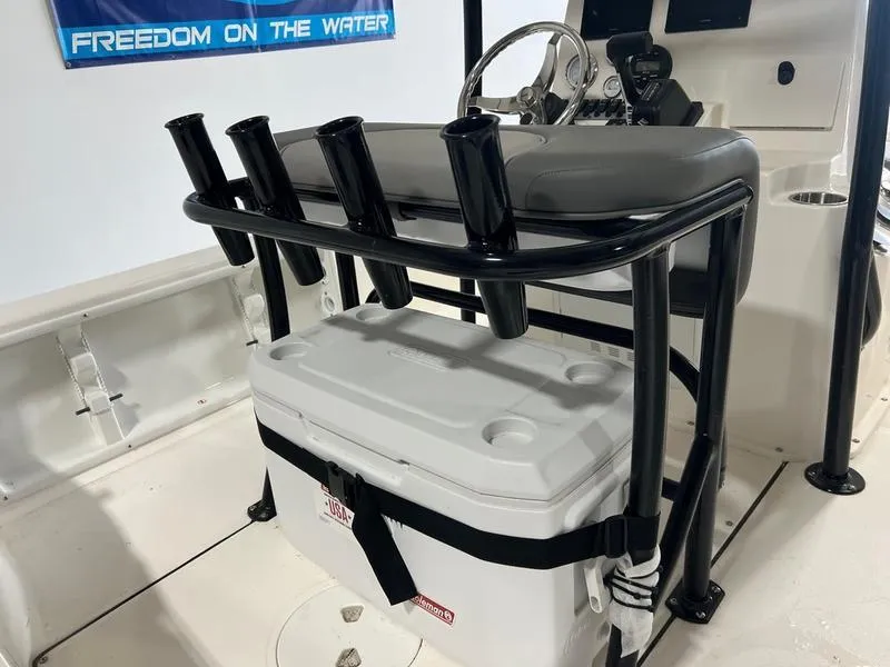 Slide: The Image of 2024 Sea Born FX 21 BAY boat interior with rod holders and cooler. - 3