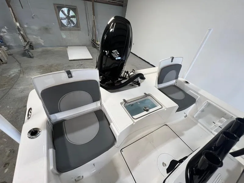 Slide: The Image of 2024 Sea Born FX 21 BAY boat interior with seating and motor. - 5