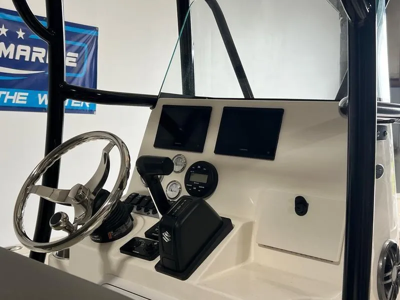 Slide: The Image of 2024 Sea Born FX 21 BAY boat console with steering wheel and digital displays. - 6