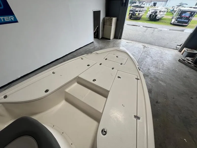 Slide: The Image of 2024 Sea Born FX 21 BAY boat interior, showcasing spacious deck and storage compartments. - 9