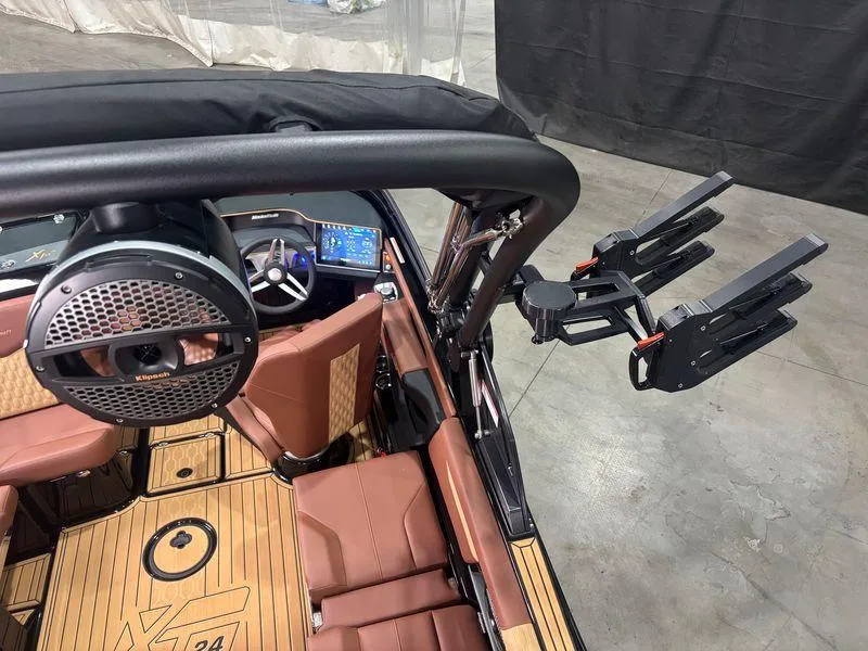 Slide: The Image of 2025 MasterCraft XT24 interior with premium seating and advanced audio system. - 10