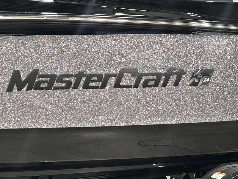 Slide: The Image of 2025 MasterCraft XT24 boat logo on a glittery surface. - 4