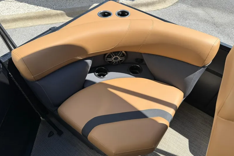 Slide: The Image of Luxurious tan seating in 2025 Viaggio Lago X-Q boat, featuring cup holders and speaker. - 15