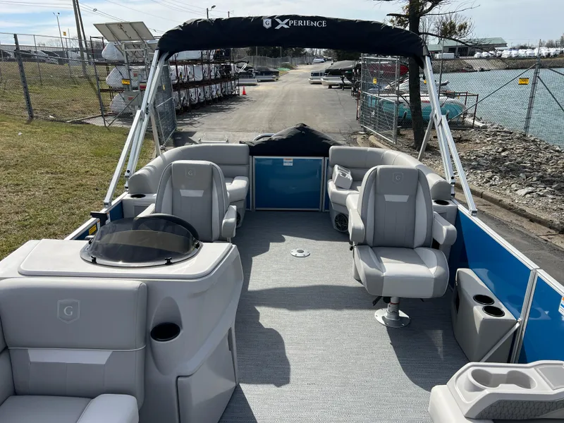 Slide: The Image of 2025 Godfrey Xperience Split Bench boat interior with gray seating and open deck layout. - 10