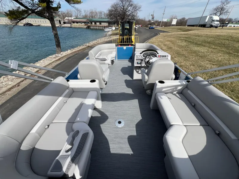 Slide: The Image of 2025 Godfrey Xperience Split Bench boat with spacious seating on a scenic waterfront. - 14