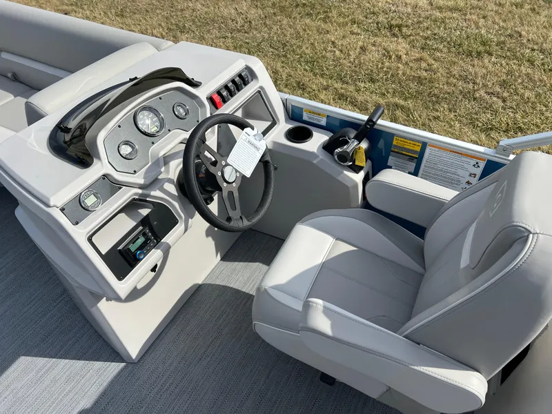 Slide: The Image of 2025 Godfrey Xperience Split Bench boat interior with steering wheel and control panel. - 16