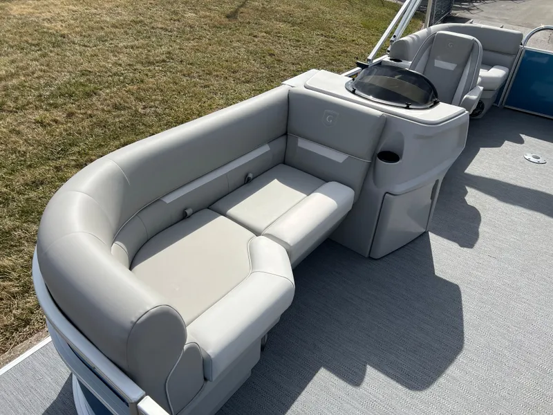 Slide: The Image of 2025 Godfrey Xperience Split Bench boat with gray seating and console. - 8