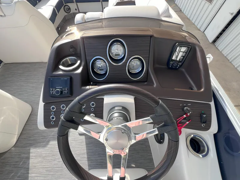 Slide: The Image of 2022 Bennington 25RSB boat dashboard with steering wheel and instrument panel. - 10