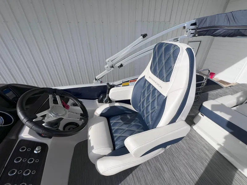 Slide: The Image of Captain's chair and helm of 2022 Bennington 25RSB boat, featuring luxurious seating and controls. - 11