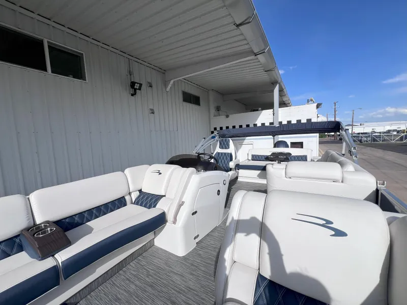 Slide: The Image of 2022 Bennington 25RSB pontoon boat with luxurious seating and modern design. - 14